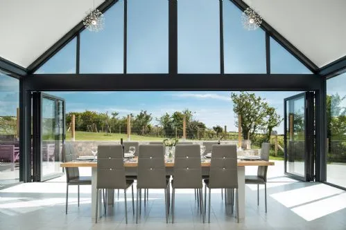 Ty Rhos Newydd Dining table and glass wall